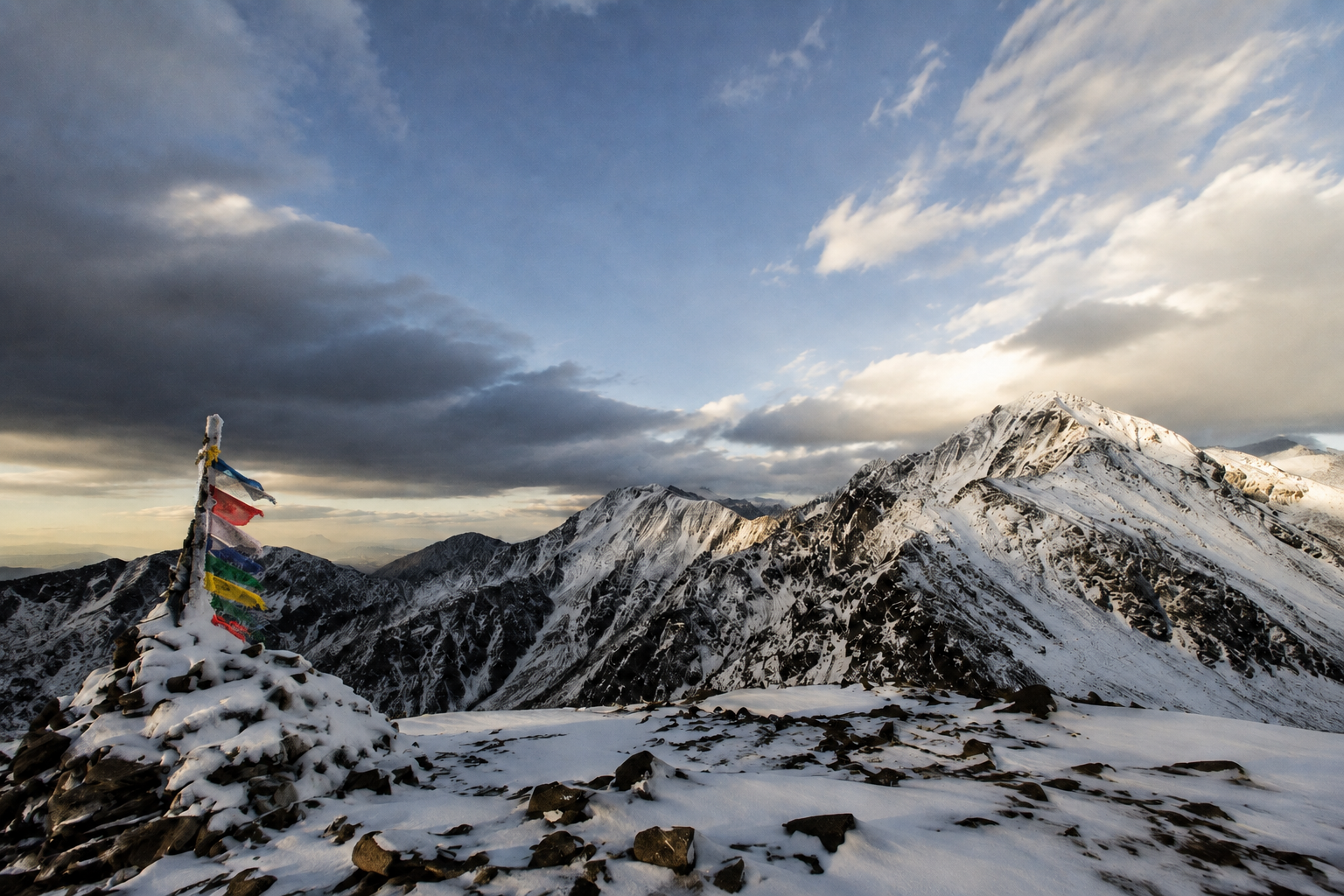Snow-covered Sangre de Cristo Mountains with colorful prayer flags near Kachina Peak